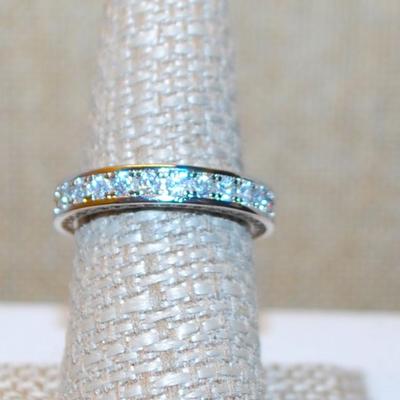 Size 6¼ Infinity Style Ring with Full Row of Round Clear Stones on a Silver Tone Band (4.4g)