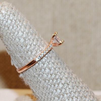 Size 7 Rose Gold 4 Prong Round Clear Main Stone Ring with 8 Accent Stone on Each Side on a Rose Gold Band (2.0g)