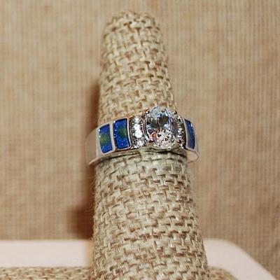 Size 8 Clear Oval Center Stone & 4 Blue & Yellow "Panels" Ring with 8 Side Accent Stones on a Silver Tone Band (5.0g)