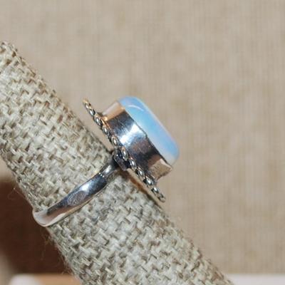 Size 6 Marked .925 Translucent Light Blue OPAL Style Gemstone Ring with a Rope Surround on a Silver-Plated Band (5.4g)