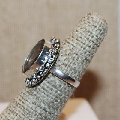 Size 9 SMOKEY TOPAZ OVAL Shape Transparent Glass Rhinestone Ring with a FULL Loop Rim Setting on a Silver Tone Band (5.1g)