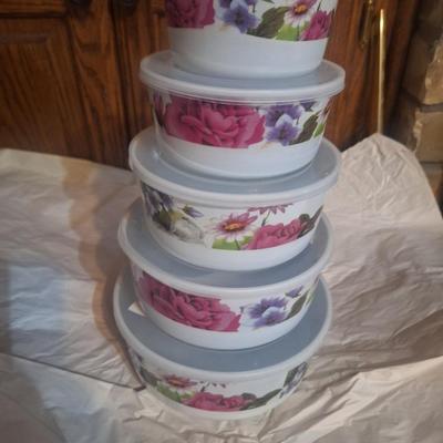 5-piece set of enamel storage bowls with lids, featuring a floral pattern.