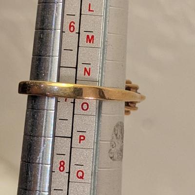 sterling silver ring with oval shaped blue topaz surrounded by small stones, likely CZ