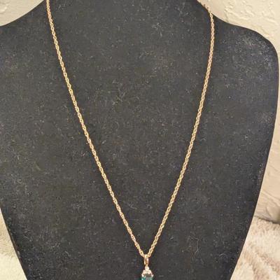 necklace and earrings set with green stones