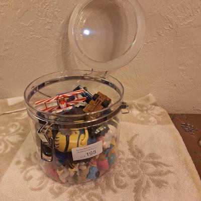 acrylic or plastic closing canister full of pocket size toys