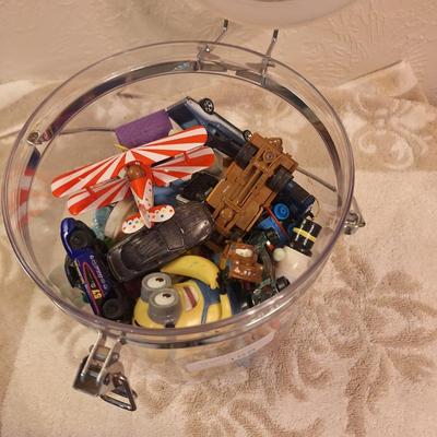 acrylic or plastic closing canister full of pocket size toys