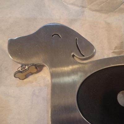 dog-shaped photo frame made from stainless steel or a similar silver-finish metal.