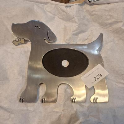 dog-shaped photo frame made from stainless steel or a similar silver-finish metal.