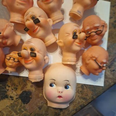 vintage doll heads, clowns, granny and grandpa etc.in plastic container