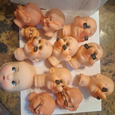 vintage doll heads, clowns, granny and grandpa etc.in plastic container