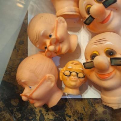 vintage doll heads, clowns, granny and grandpa etc.in plastic container