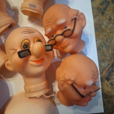 vintage doll heads, clowns, granny and grandpa etc.in plastic container