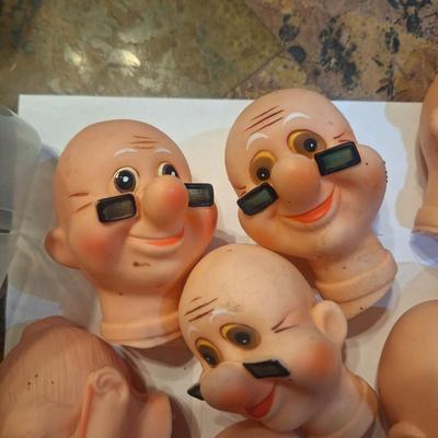 vintage doll heads, clowns, granny and grandpa etc.in plastic container