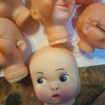 vintage doll heads, clowns, granny and grandpa etc.in plastic container