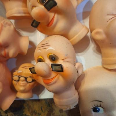 vintage doll heads, clowns, granny and grandpa etc.in plastic container