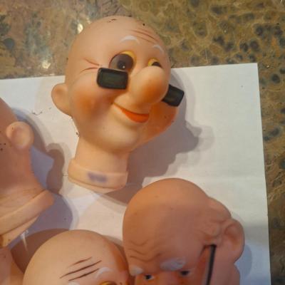 vintage doll heads, clowns, granny and grandpa etc.in plastic container