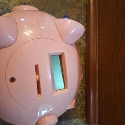 pink plastic piggy bank- counts coins