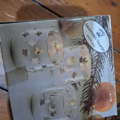 set of silver-plated tealight candle holders with glass shades. And two small glass jar candles