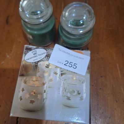 set of silver-plated tealight candle holders with glass shades. And two small glass jar candles