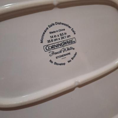 Corning Ware French White III Serving Platter with a wood cutting board