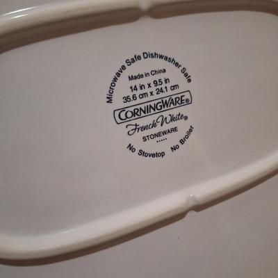 Corning Ware French White III Serving Platter with a wood cutting board