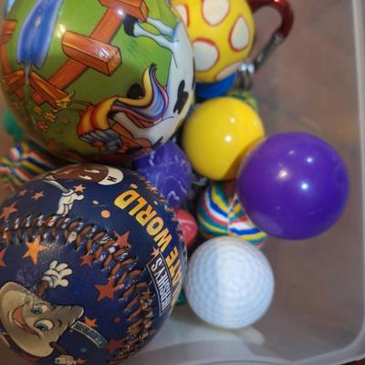 container of various balls and toys, one Hershey's base ball, several bouncy balls. Etc.