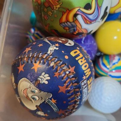 container of various balls and toys, one Hershey's base ball, several bouncy balls. Etc.