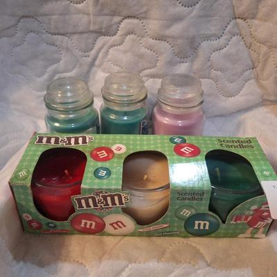 2 back of M&Ms scented candles and 3 small glass jar candles