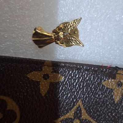 brown makeup bag with brushes and angel pin