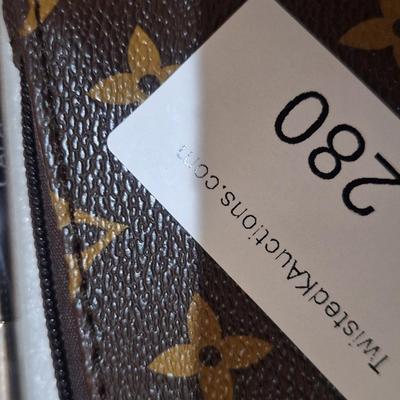 brown makeup bag with brushes and angel pin