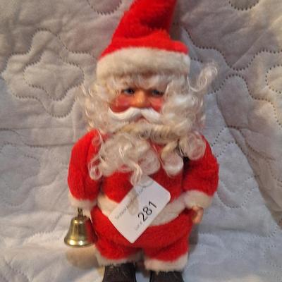 vintage animated Santa Claus doll with a rubber face and a bell. - has wheels on feet