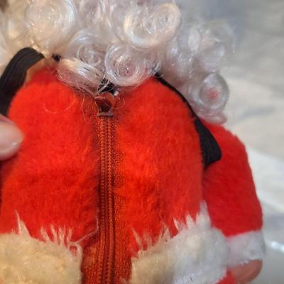 vintage animated Santa Claus doll with a rubber face and a bell. - has wheels on feet