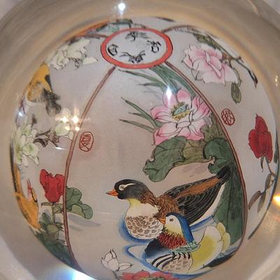 Chinese reverse hand-painted glass sphere, also known as an inside-painted glass ball or paperweight.