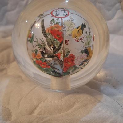 Chinese reverse hand-painted glass sphere, also known as an inside-painted glass ball or paperweight.