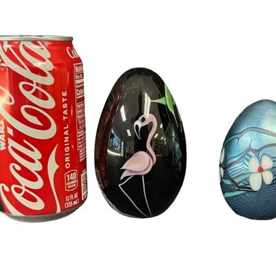 Sale Photo Thumbnail #7: Two pieces. One features a flamingo. The other is iridescent blue with white dogwood flowers. Measurement of largest: 4”H. Pre-auction estimate: $200-$400. [MA]