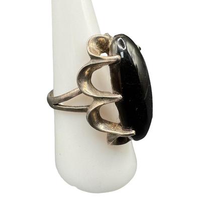 Sale Photo Thumbnail #35: This ring features an elongated oval black onyx. The ring size is 7.75. [GD]