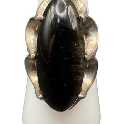 Sale Photo Thumbnail #34: This ring features an elongated oval black onyx. The ring size is 7.75. [GD]