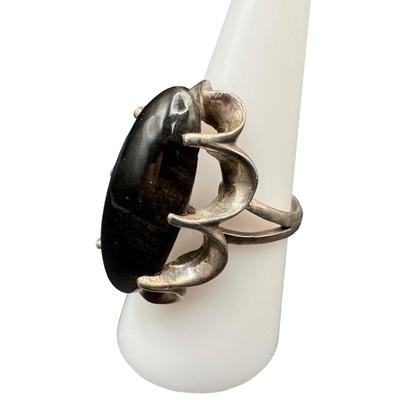 Sale Photo Thumbnail #36: This ring features an elongated oval black onyx. The ring size is 7.75. [GD]