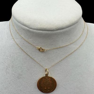 Sale Photo Thumbnail #92: [2.90g] This necklace features a religious pendant on a delicate cable chain. Length of chain: 20”L. Gold content confirmed using Niton XRF precious metals analyzer. [GD]