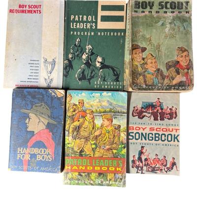 Sale Photo Thumbnail #134: Includes two Boy Scout pocket knives, a belt buckle, three medals, an Eagle Scout award in sterling silver, a merit badge sash, and six books. Total of 14 pieces. [KD]