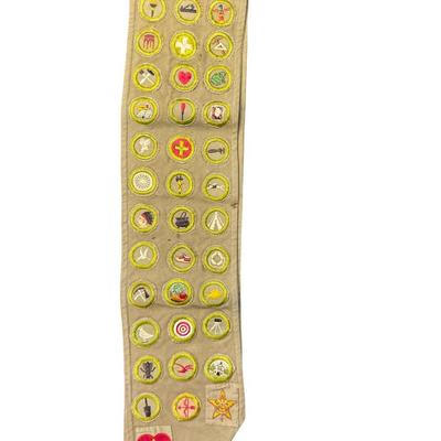 Sale Photo Thumbnail #132: Includes two Boy Scout pocket knives, a belt buckle, three medals, an Eagle Scout award in sterling silver, a merit badge sash, and six books. Total of 14 pieces. [KD]