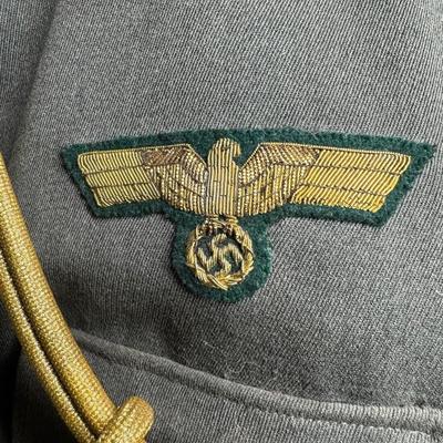 Sale Photo Thumbnail #152: Includes a tunic and trousers. Possibly a prop uniform, reproduction, or for movie use. Includes medals, shoulder boards, ribbon bar, and more. This has been in a smoky environment, and needs to be cleaned. Pre-auction estimate: $150-$250. [JS]