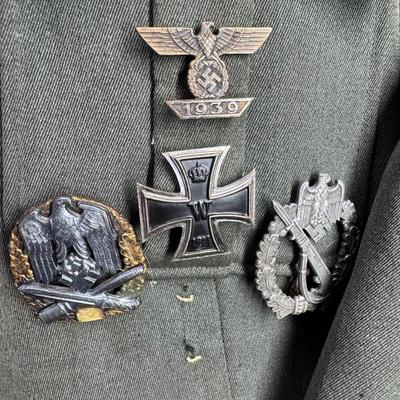 Sale Photo Thumbnail #154: Includes a tunic and trousers. Possibly a prop uniform, reproduction, or for movie use. Includes medals, shoulder boards, ribbon bar, and more. This has been in a smoky environment, and needs to be cleaned. Pre-auction estimate: $150-$250. [JS]