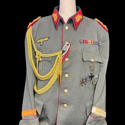 Sale Photo Thumbnail #151: Includes a tunic and trousers. Possibly a prop uniform, reproduction, or for movie use. Includes medals, shoulder boards, ribbon bar, and more. This has been in a smoky environment, and needs to be cleaned. Pre-auction estimate: $150-$250. [JS]