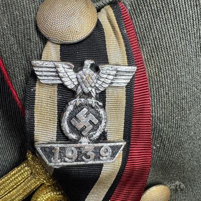Sale Photo Thumbnail #153: Includes a tunic and trousers. Possibly a prop uniform, reproduction, or for movie use. Includes medals, shoulder boards, ribbon bar, and more. This has been in a smoky environment, and needs to be cleaned. Pre-auction estimate: $150-$250. [JS]