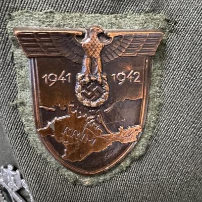 Sale Photo Thumbnail #157: Includes a tunic and trousers. Possibly a prop uniform, reproduction, or for movie use. Includes medals, shoulder boards, ribbon bar, and more. This has been in a smoky environment, and needs to be cleaned. Pre-auction estimate: $150-$250. [JS]