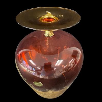 Sale Photo Thumbnail #166: This cranberry glass vase has raised flowers and ornate gold decoration. There is still a paper label affixed. No obvious chips or cracks. Measurement: 8”H x 6” Diameter (at widest point). Pre-auction estimate: $50-$100. [RE]