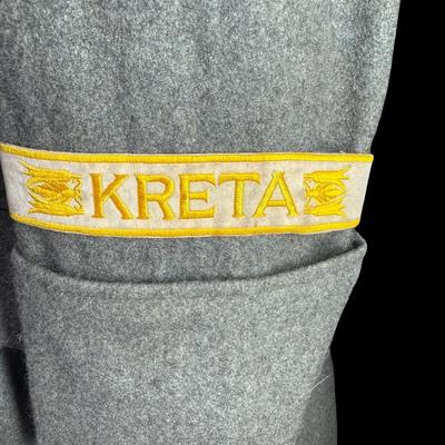 Sale Photo Thumbnail #175: This would have been worn by a General Officer. It is possibly a reproduction or prop. Made from wool, in a field grey color. The red piping on the cuffs aligns with an M36 model greatcoat. Possibly size XL. This has been in a smoky environment, and needs