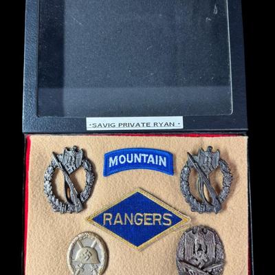 Sale Photo Thumbnail #182: Includes Mountain Division tab, Ranger patch, and four Nazi/Third Reich metal badges. Total of six pieces under glass. Age related wear. [JS]