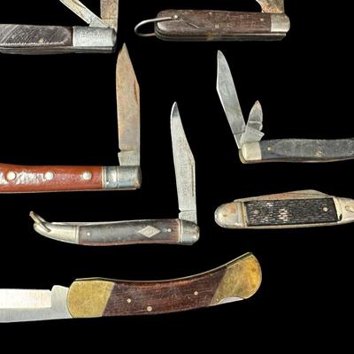 Sale Photo Thumbnail #247: Includes Kabar, Camper, Barlow, Puma, and more. Total of 22 pieces. Some pieces have age related wear, including stained/rusted blades, and possibly some chipped or cracked handles. [KD]